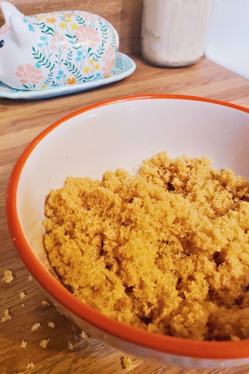 easy homemade brown sugar made with molasses and granulated sugar in a Pioneer Woman bowl on the counter.
