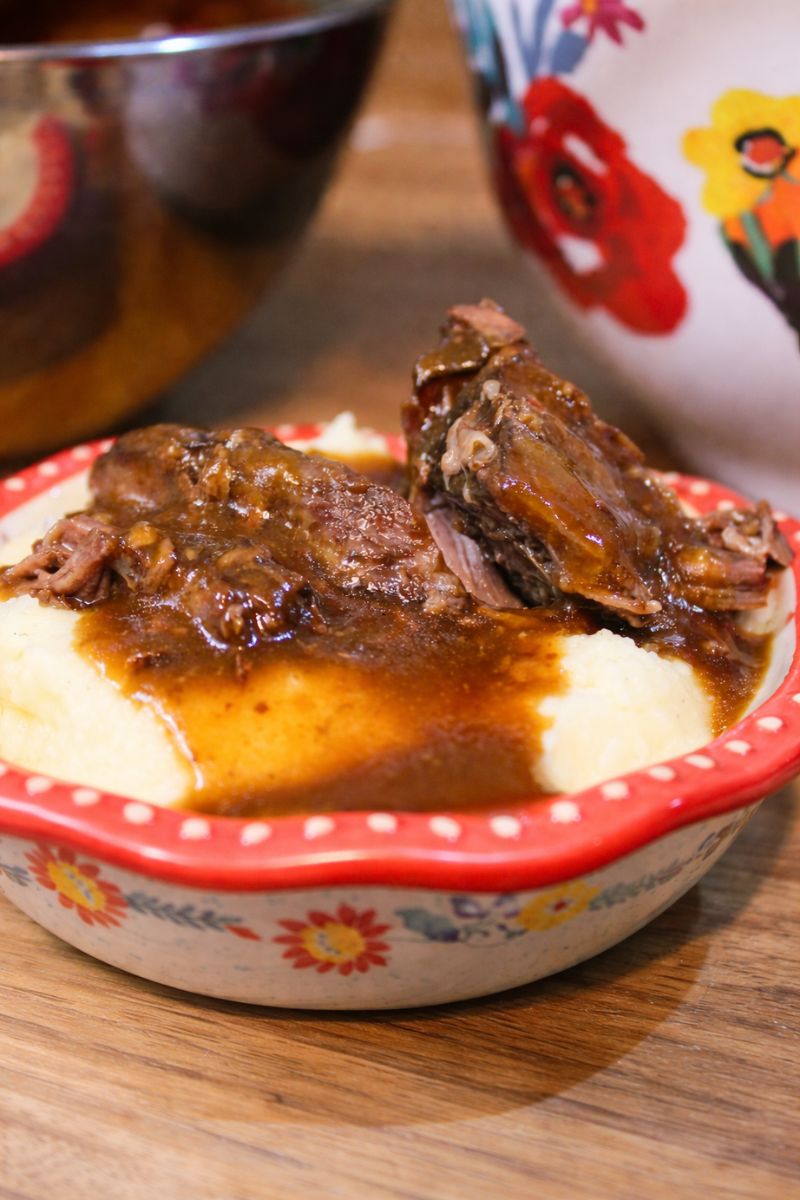 Tender crock pot chuck roast with rich brown gravy served over creamy mashed potatoes, easy slow cooker pot roast recipe for a cozy, comforting family dinner.