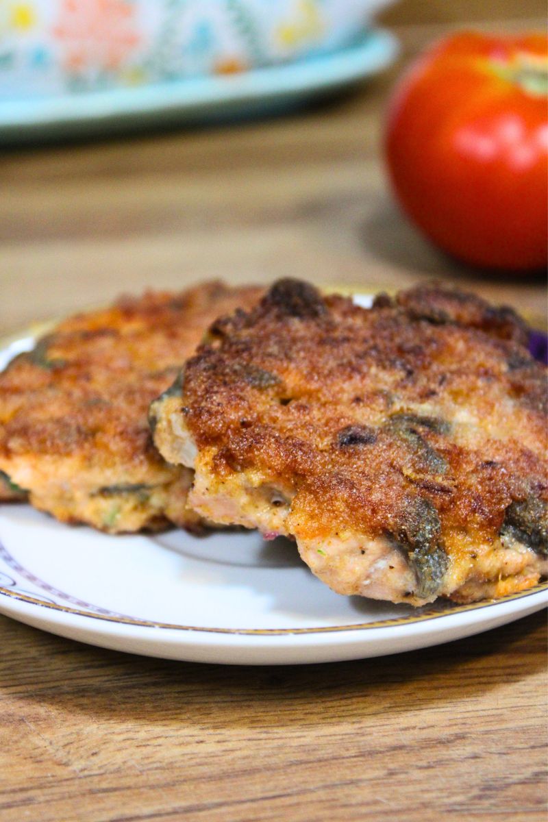 Crispy homemade fresh salmon patties served on a plate, golden brown outside and tender inside.
